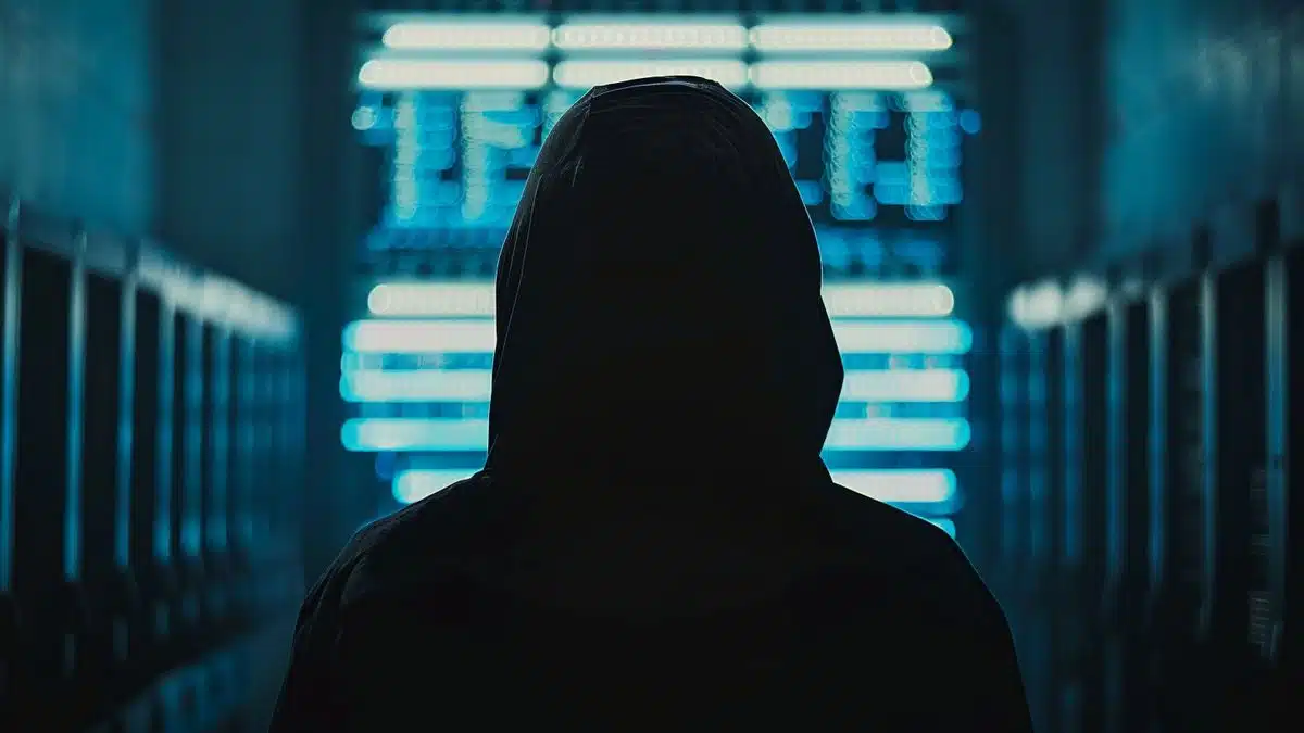 Hacker silhouette in the background, symbolizing security risks associated with Recall.