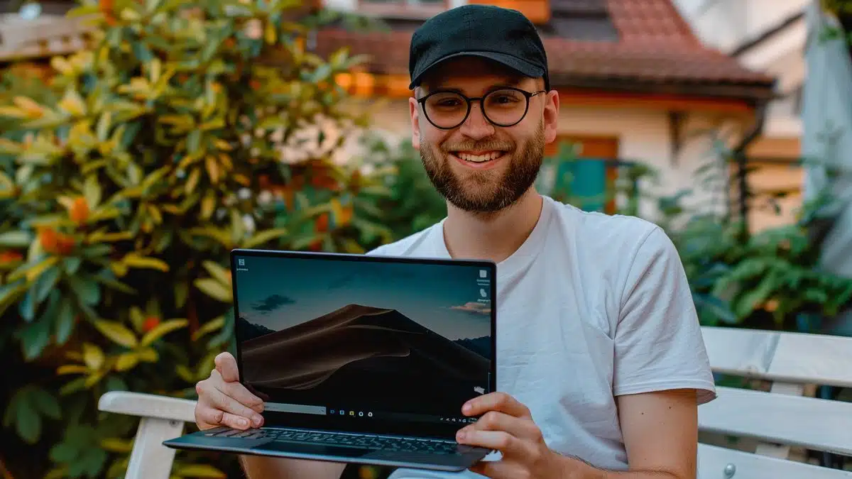 Happy user holding a Windows laptop, relieved about prolonged support.