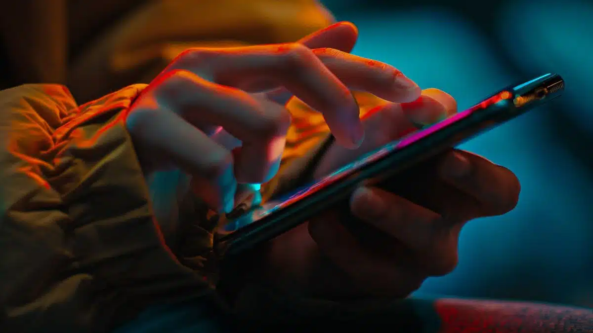 Hand typing a unique and recognizable iPhone name on the screen.